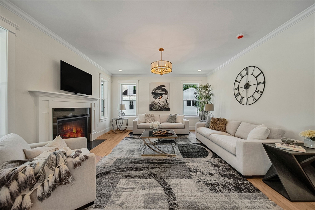 120 Lawton Road Needham, MA 02492 - Photo 10 of 34 a living room with furniture a fireplace and a flat screen tv