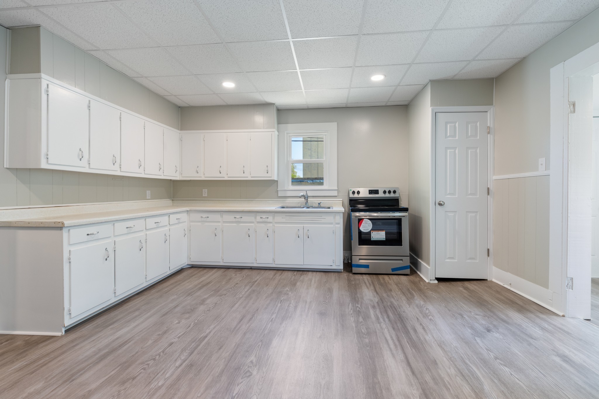 300 West Railroad Street Dickson, TN 37055 - Photo 24 of 58 a kitchen with wooden floors and appliances