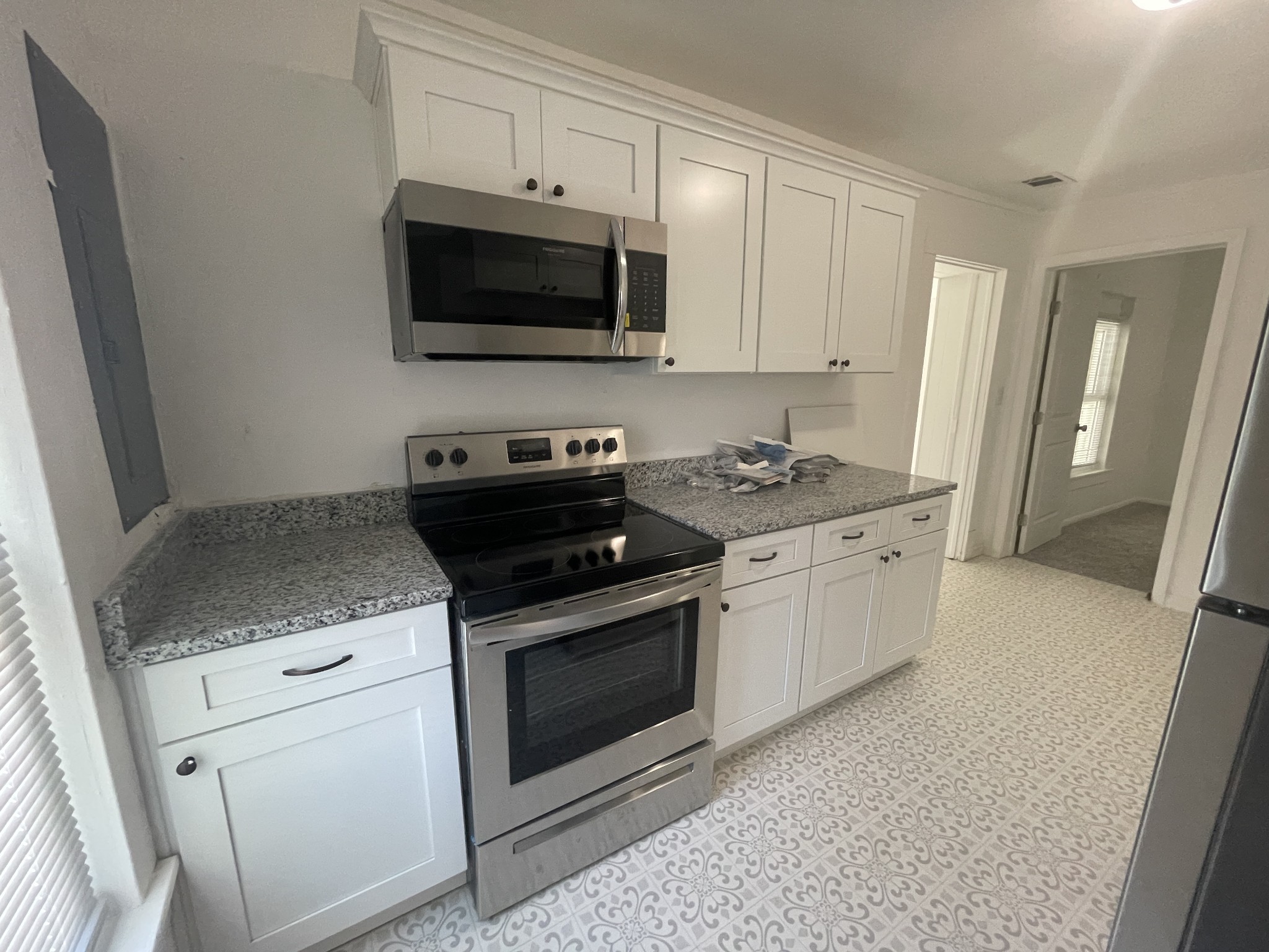 300 West Railroad Street Dickson, TN 37055 - Photo 41 of 58 a kitchen with stainless steel appliances granite countertop a stove a microwave and a refrigerator
