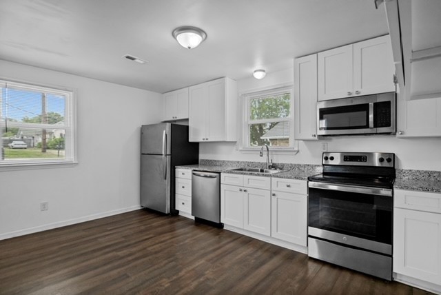 300 West Railroad Street Dickson, TN 37055 - Photo 53 of 58 a kitchen with granite countertop a refrigerator stove and microwave