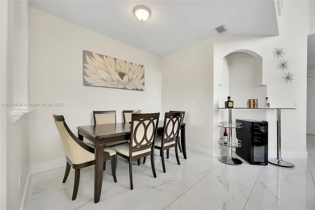 a view of a dining room with furniture and fireplace