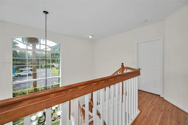 a view of entryway and hall with wooden floor