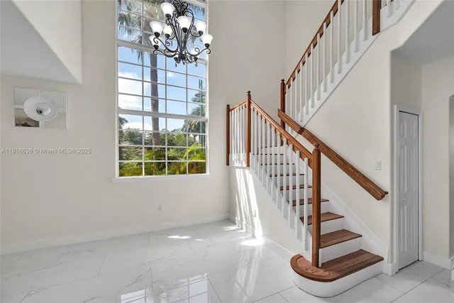 a view of entryway with wooden floor and front door