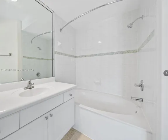 a bathroom with a sink a mirror and a bathtub