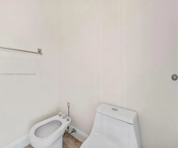 a white toilet sitting next to a white sink