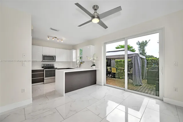 a large kitchen with cabinets and stainless steel appliances