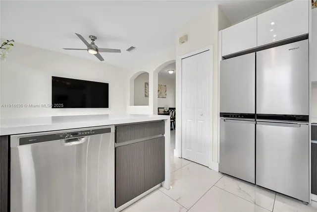 a kitchen with stainless steel appliances a refrigerator and a microwave
