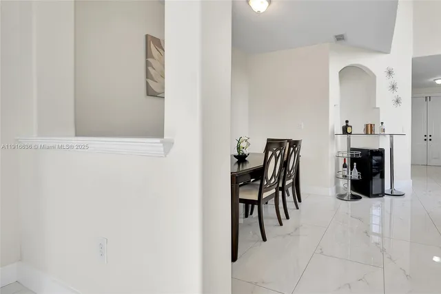 a dining room with furniture and a view of kitchen