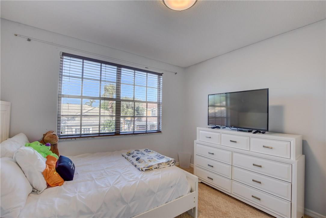 10934 Ravel Court Boca Raton, FL 33498 - Photo 26 of 43 a bedroom with a bed and television