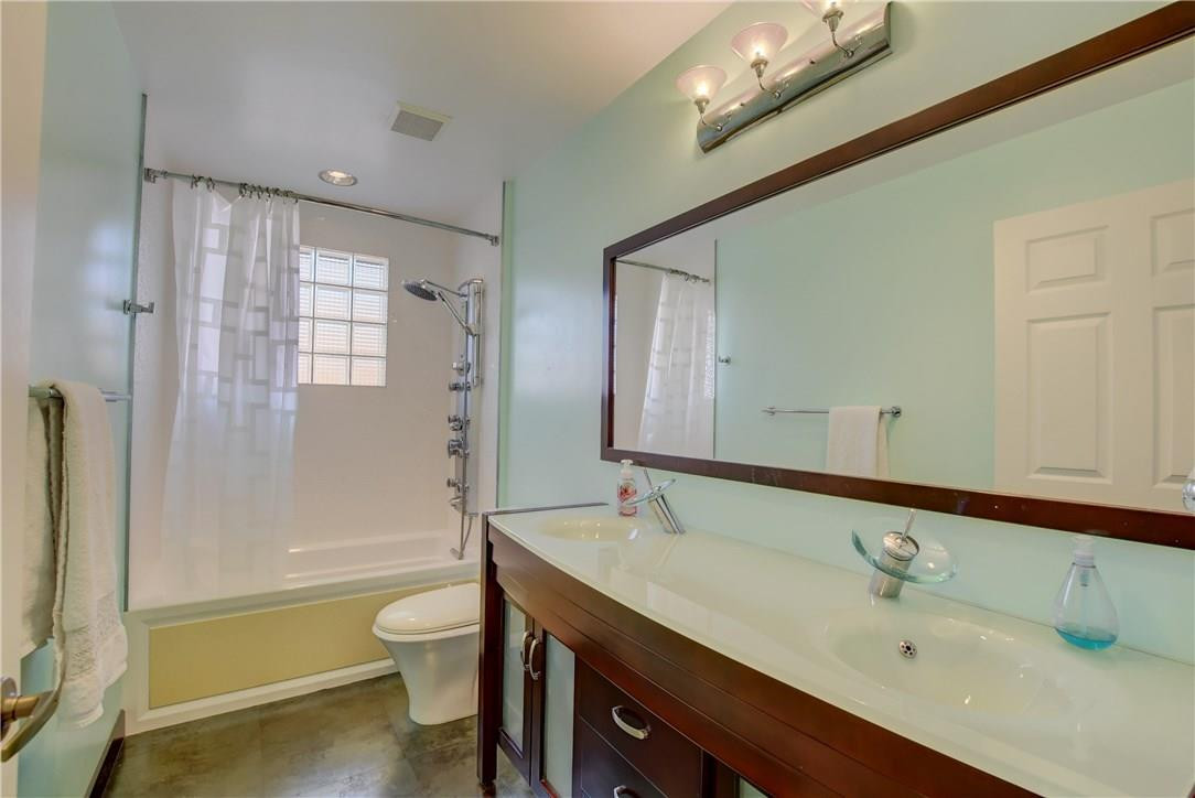 10934 Ravel Court Boca Raton, FL 33498 - Photo 29 of 43 a bathroom with a bathtub shower sink vanity and a toilet