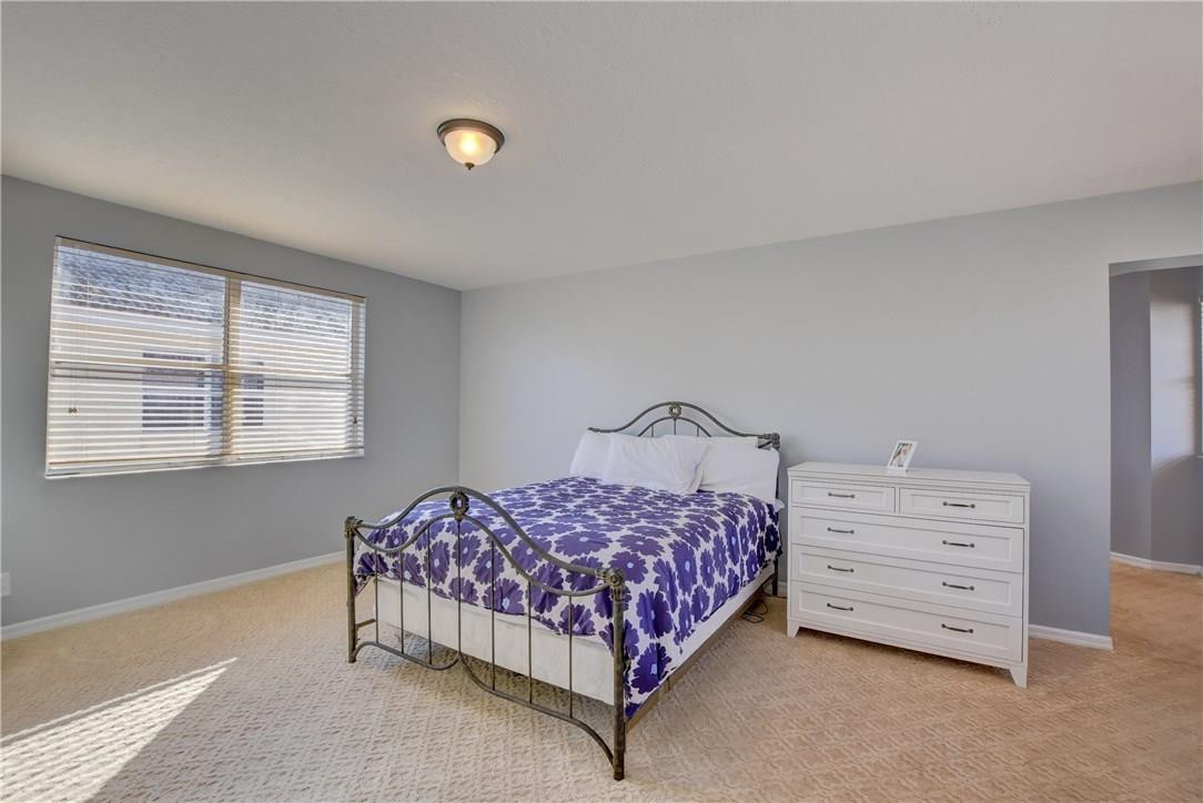 10934 Ravel Court Boca Raton, FL 33498 - Photo 30 of 43 a bedroom with a bed and a window