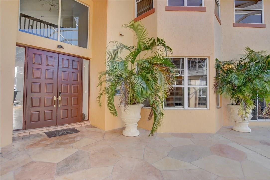 10934 Ravel Court Boca Raton, FL 33498 - Photo 3 of 43 a view of a building with a potted plant and a garage