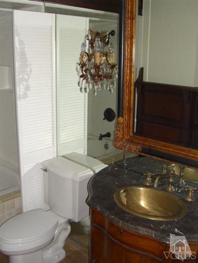 2901 Peninsula Road, Unit 242 Oxnard, CA 93035 - Photo 15 of 30 a bathroom with a sink a toilet and mirror
