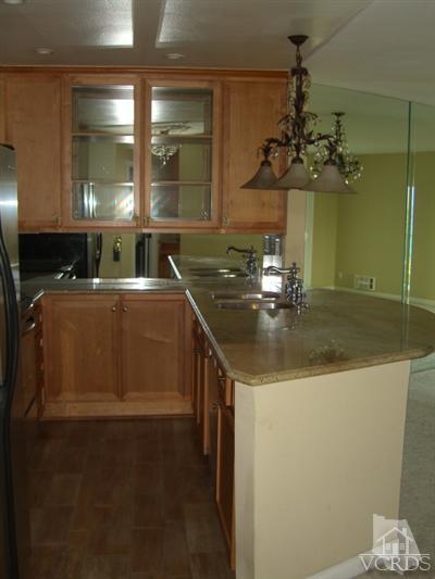 2901 Peninsula Road, Unit 242 Oxnard, CA 93035 - Photo 8 of 30 a kitchen with a sink a counter top space and cabinets
