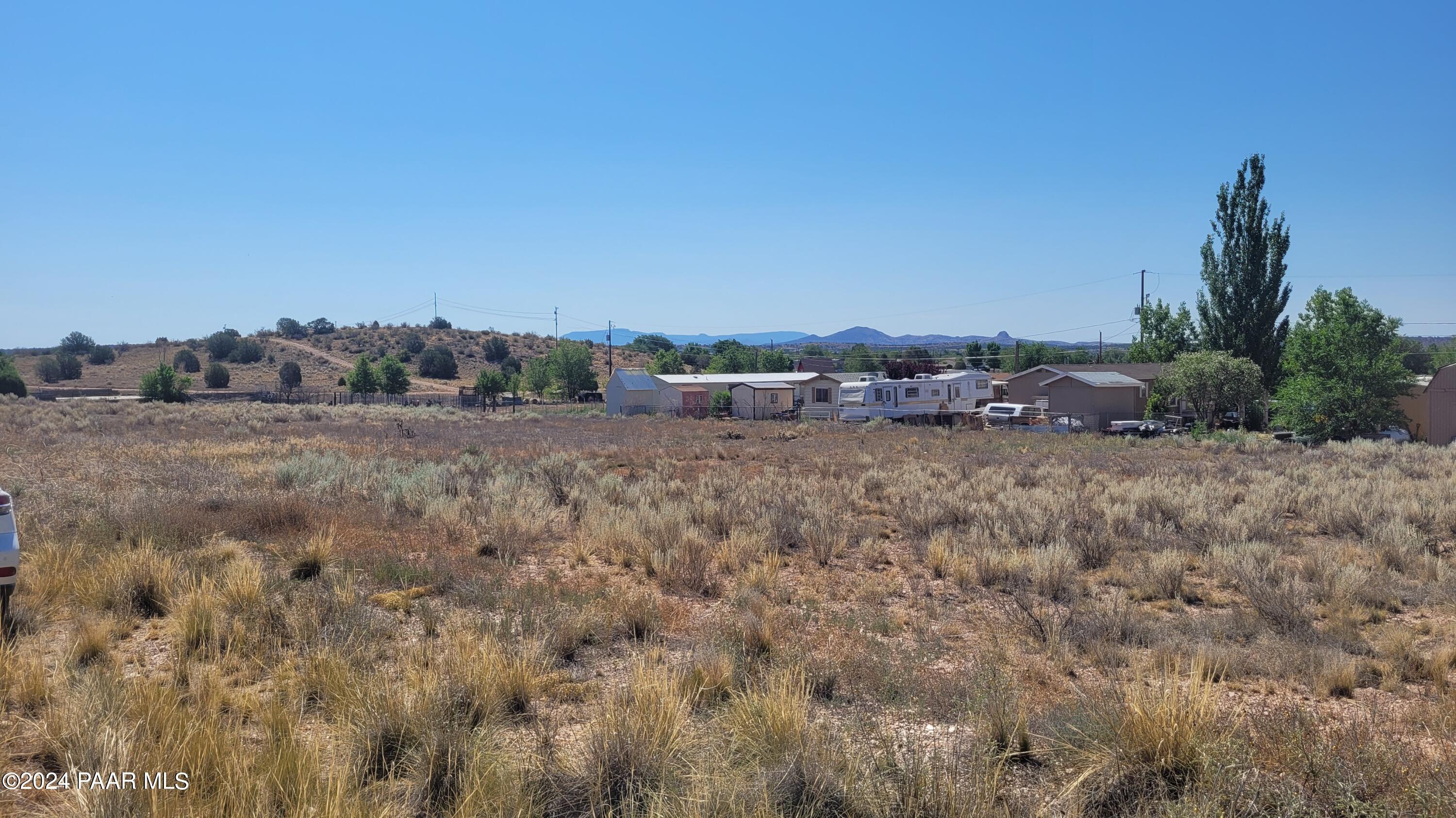 29 East Abra Road Paulden, AZ 86334 - Photo 2 of 6 a view of a dry yard with trees