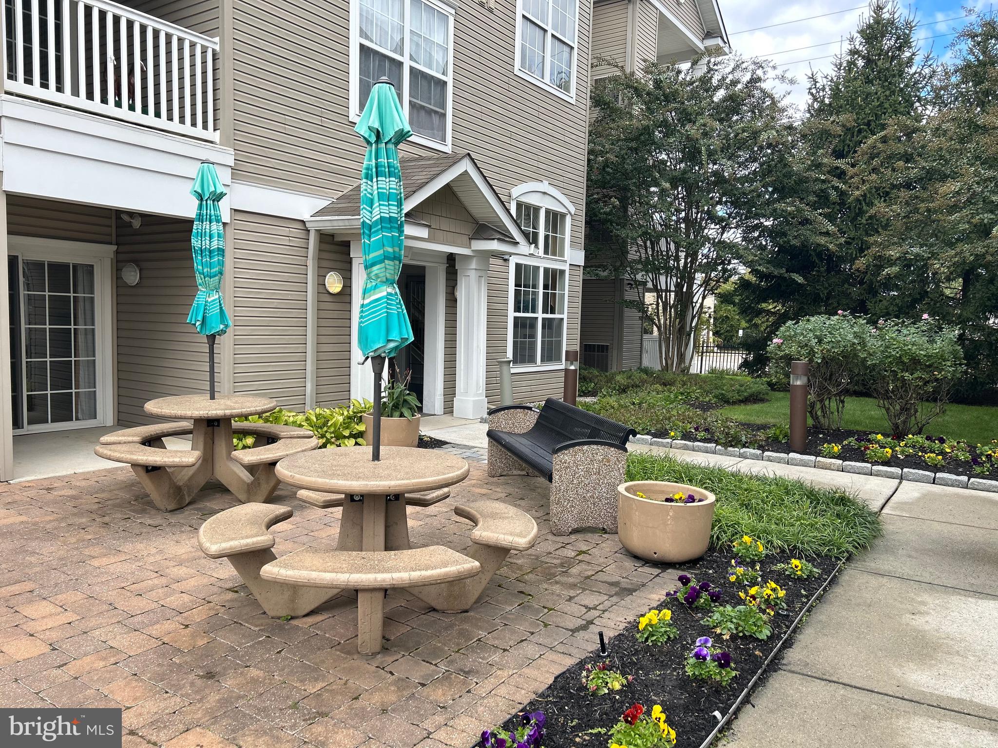 7320 Maple Avenue, Unit 231 Pennsauken, NJ 08109 - Photo 11 of 15 a view of a patio with couches table and chairs and potted plants