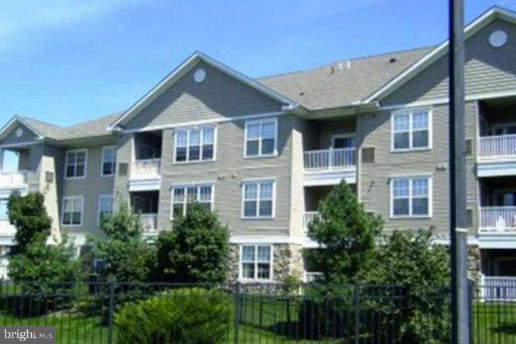 7320 Maple Avenue, Unit 231 Pennsauken, NJ 08109 - Photo 2 of 15 a front view of a house with a yard