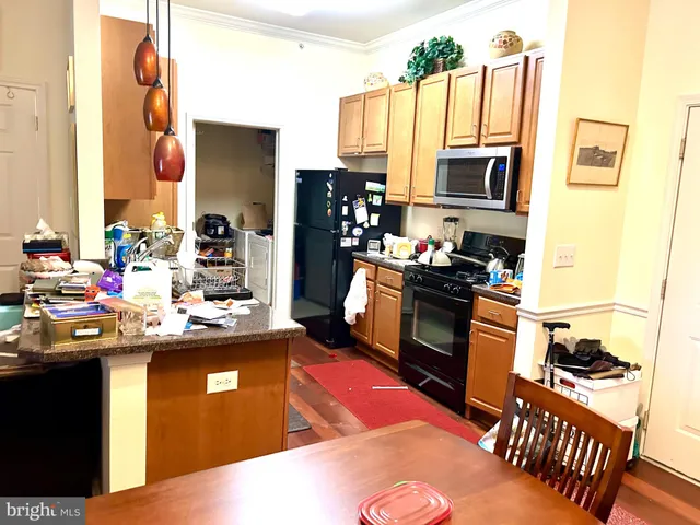 a kitchen with granite countertop a sink stove and refrigerator