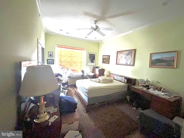 a bedroom with a bed and ceiling fan