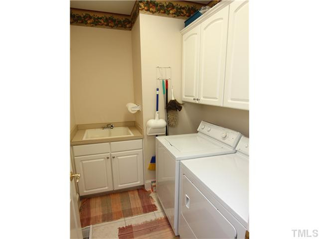 12501 Ribbongrass Court Raleigh, NC 27614 - Photo 23 of 25 Plenty of space is the 2nd floor laundry/utility room with a sink and cabinet space. Laundry Room