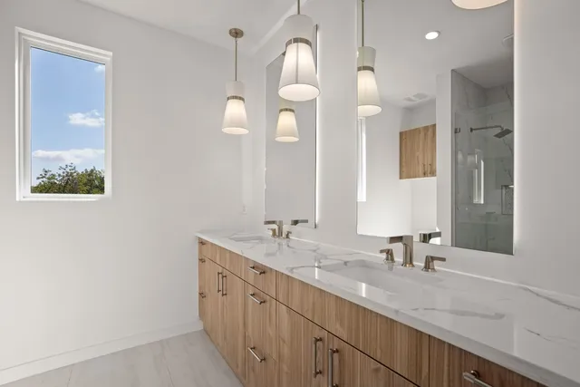 a bathroom with a double vanity sink and a mirror