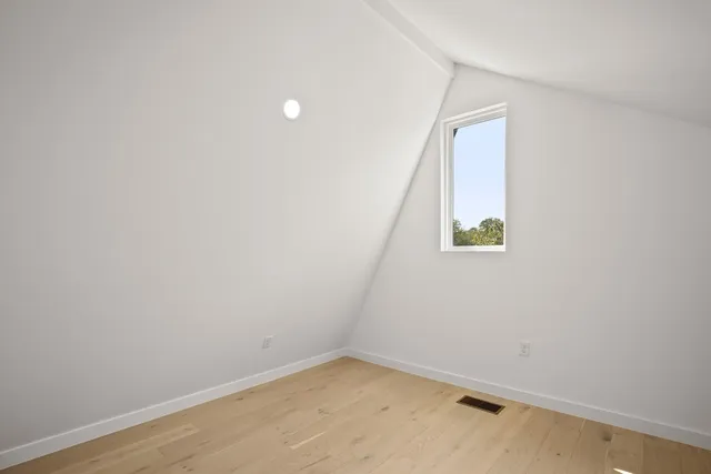 a bathroom with a granite countertop bathtub sink vanity mirror and toilet