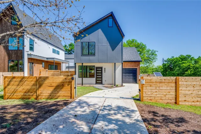 a view of a house with a tree in the yard