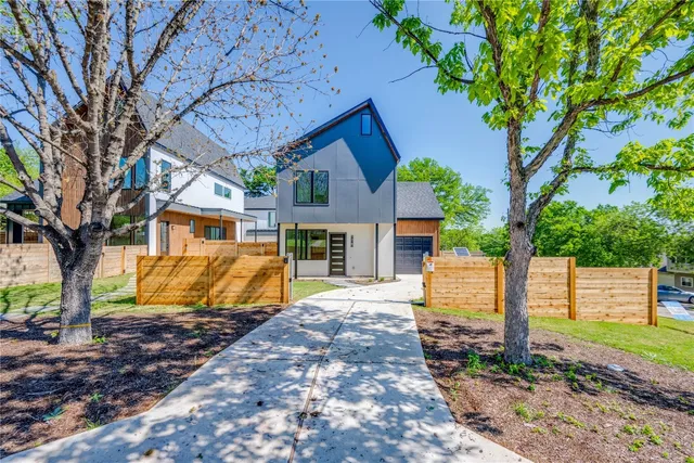 a view of a backyard with wooden fence