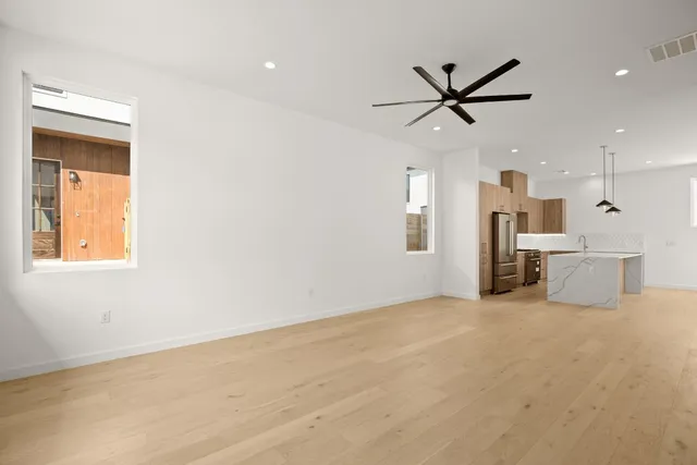 a view of a livingroom with a ceiling fan and window