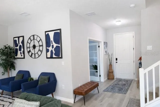 a view of a livingroom with wooden floor and a window