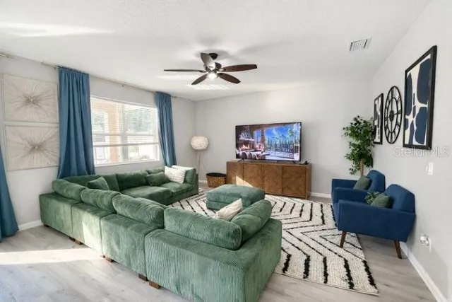 a kitchen with a table chairs and a chandelier