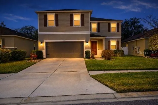 a front view of a house with a yard and garage
