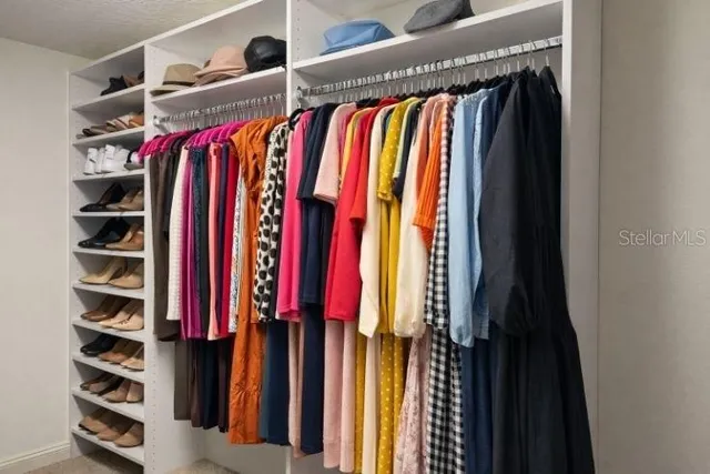 a bathroom with a granite countertop sink a toilet and a mirror