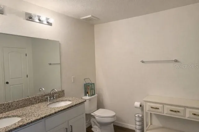 a bedroom with two beds and a dresser