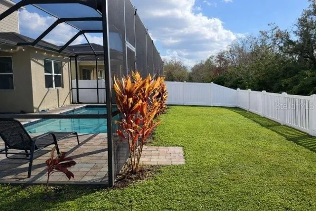 a view of a backyard with sitting area