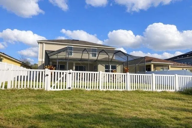 a living room with couches and a dining table with wooden floor