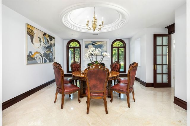a view of a dining room with furniture and chandelier