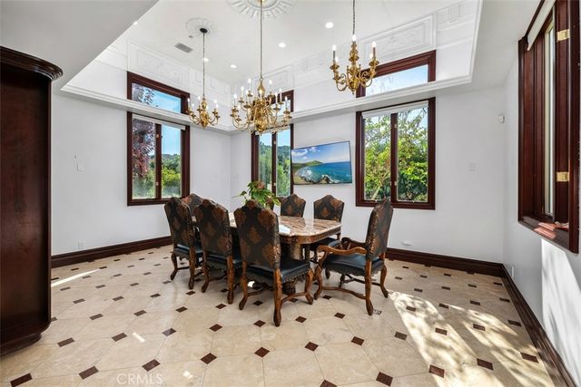 a view of a dining room with furniture and a chandelier