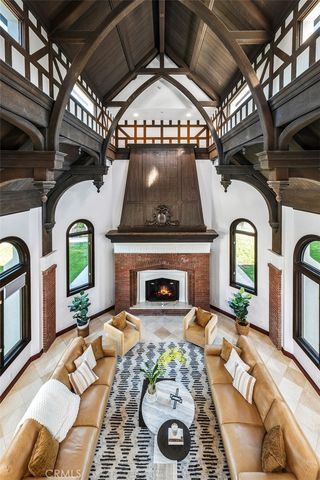 a view of staircase with a large window and chandelier