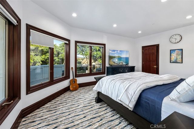 a spacious bedroom with a bed and a large mirror