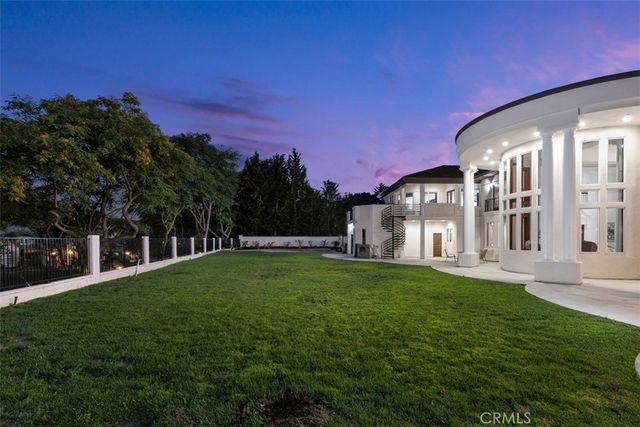 a living room with fireplace furniture and a chandelier