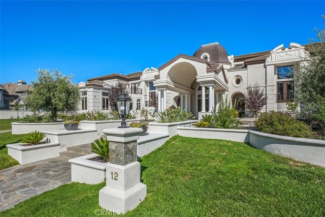 a front view of a house with a garden and patio
