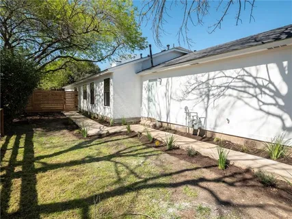 a view of swimming pool with a backyard and trees