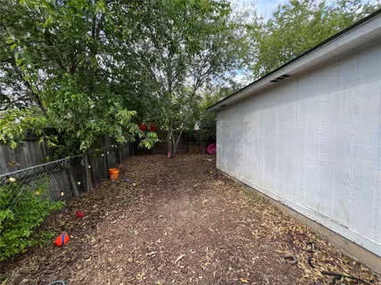 a backyard of a house with lots of green space and trees all around