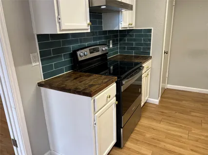 a kitchen with a stove and a microwave