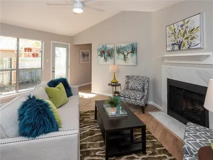 a living room with furniture and a fireplace