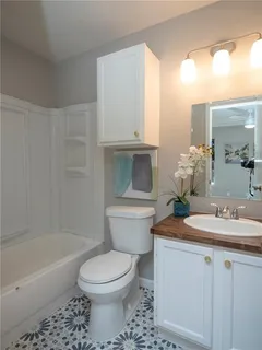 a bathroom with a sink a toilet and bathtub