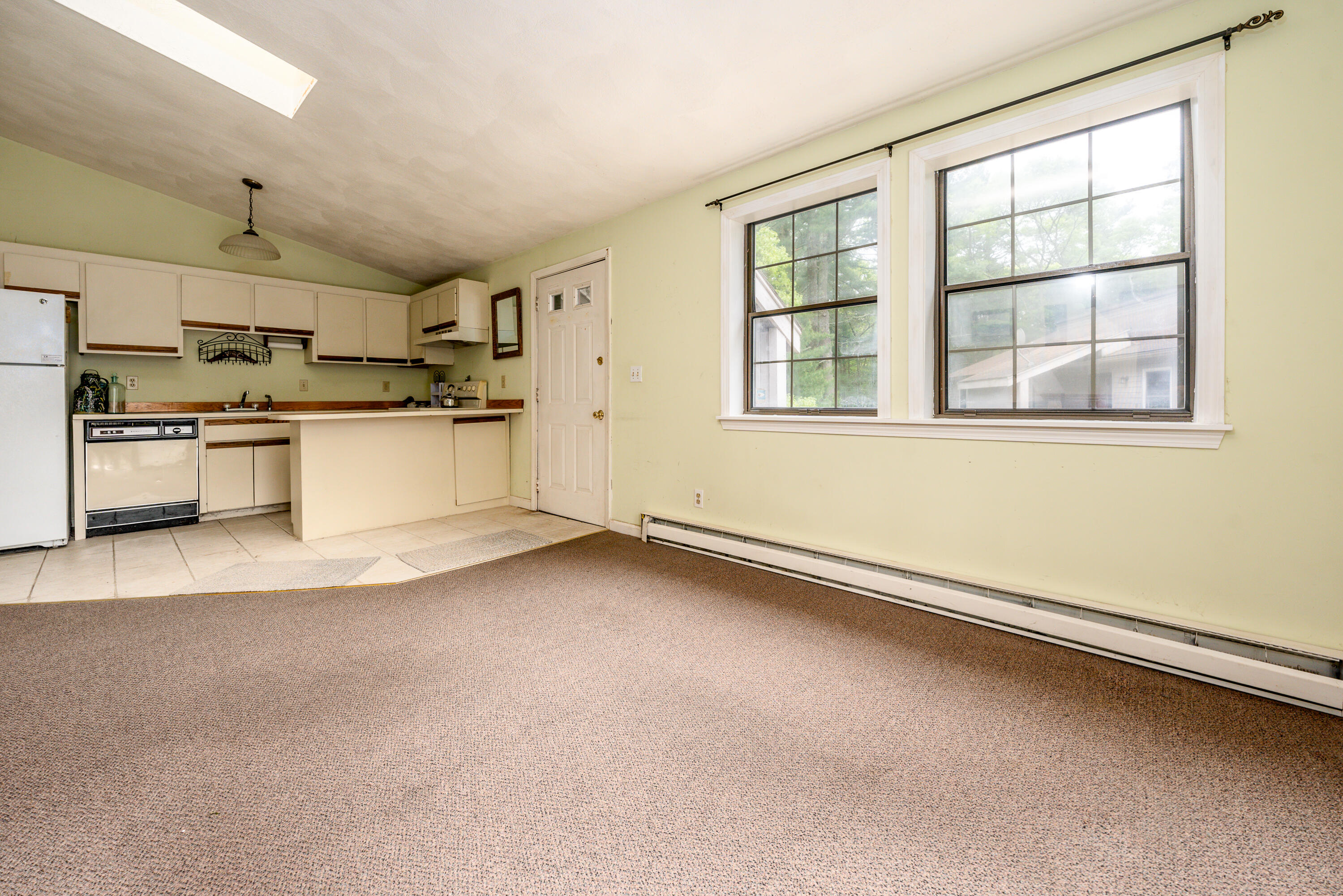 70 Cape Drive, Unit 12D Mashpee, MA 02649 - Photo 5 of 13 a kitchen with a sink wooden floor and stainless steel appliances