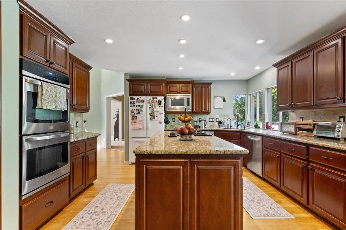 2565 Bertella Road Cameron Park, CA 95682 - Photo 20 of 31 a kitchen with stainless steel appliances granite countertop a refrigerator stove and oven
