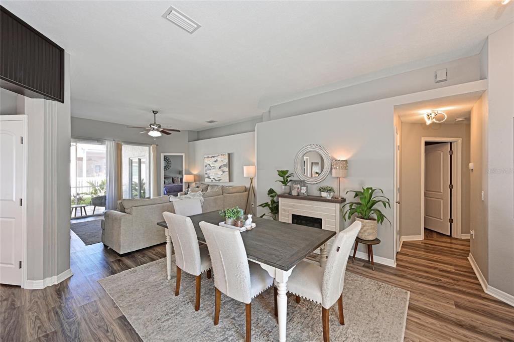 12709 Nightshade Place Lakewood Ranch, FL 34202 - Photo 14 of 53 a dining room with furniture a rug and wooden floor